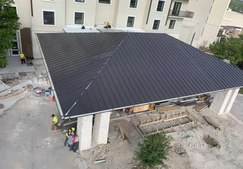 Metal roofing installation team working on a commercial building in Westwego