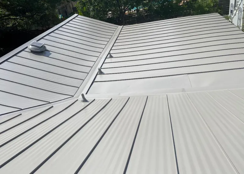 Solar attic fan installed on a metal roof for Roof Ventilation in Westwego